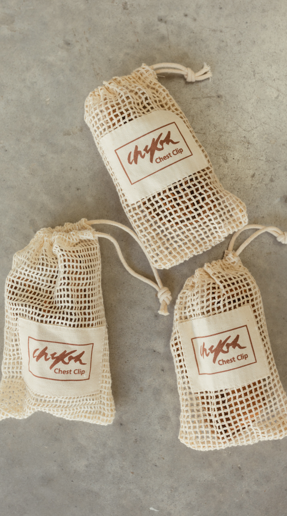 Packaging of the Chekoh Chest Strap, a beige natural cotton mesh pouch with Chekoh Logo 