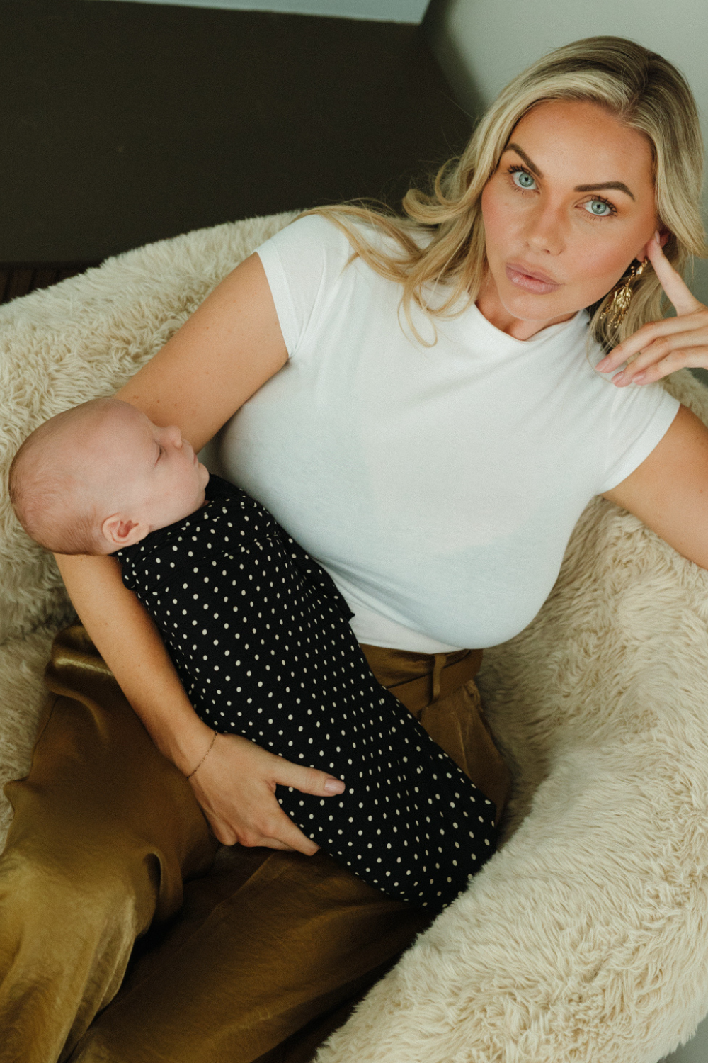 A sleeping baby is comfortable and content all swaddled up in a super soft Chekoh Baby Swaddle in the new Polka Dot print