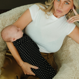 A sleeping baby is comfortable and content all swaddled up in a super soft Chekoh Baby Swaddle in the new Polka Dot print