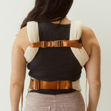 Example of how to wear the Chekoh Chest Strap - image shows woman wearing the Clip carrier with the Chest Strap affixed at her back to create a 'H' style carry.