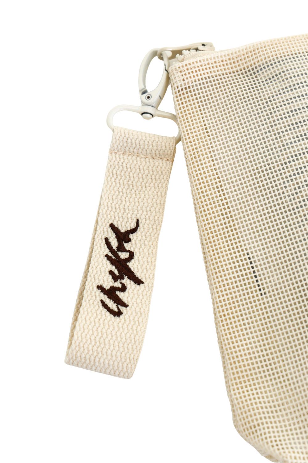 Close up detail shot of removable clip detail with Chekoh logo embroidered in dark brown thread