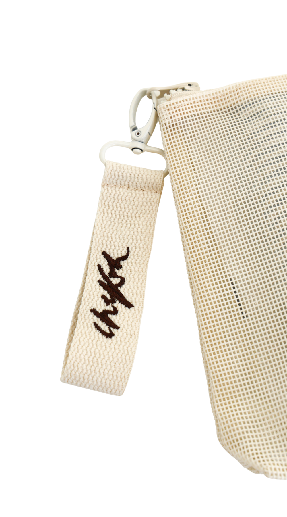 Close up detail shot of removable clip detail with Chekoh logo embroidered in dark brown thread