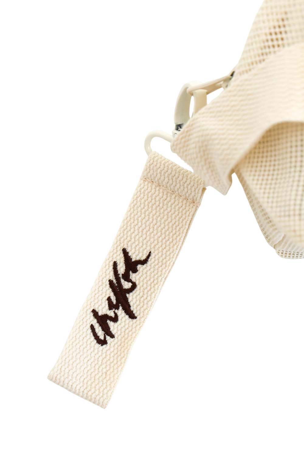 Close up of detachable embroidered Chekoh logo key ring - comes attached to the Clip Storage Bag.