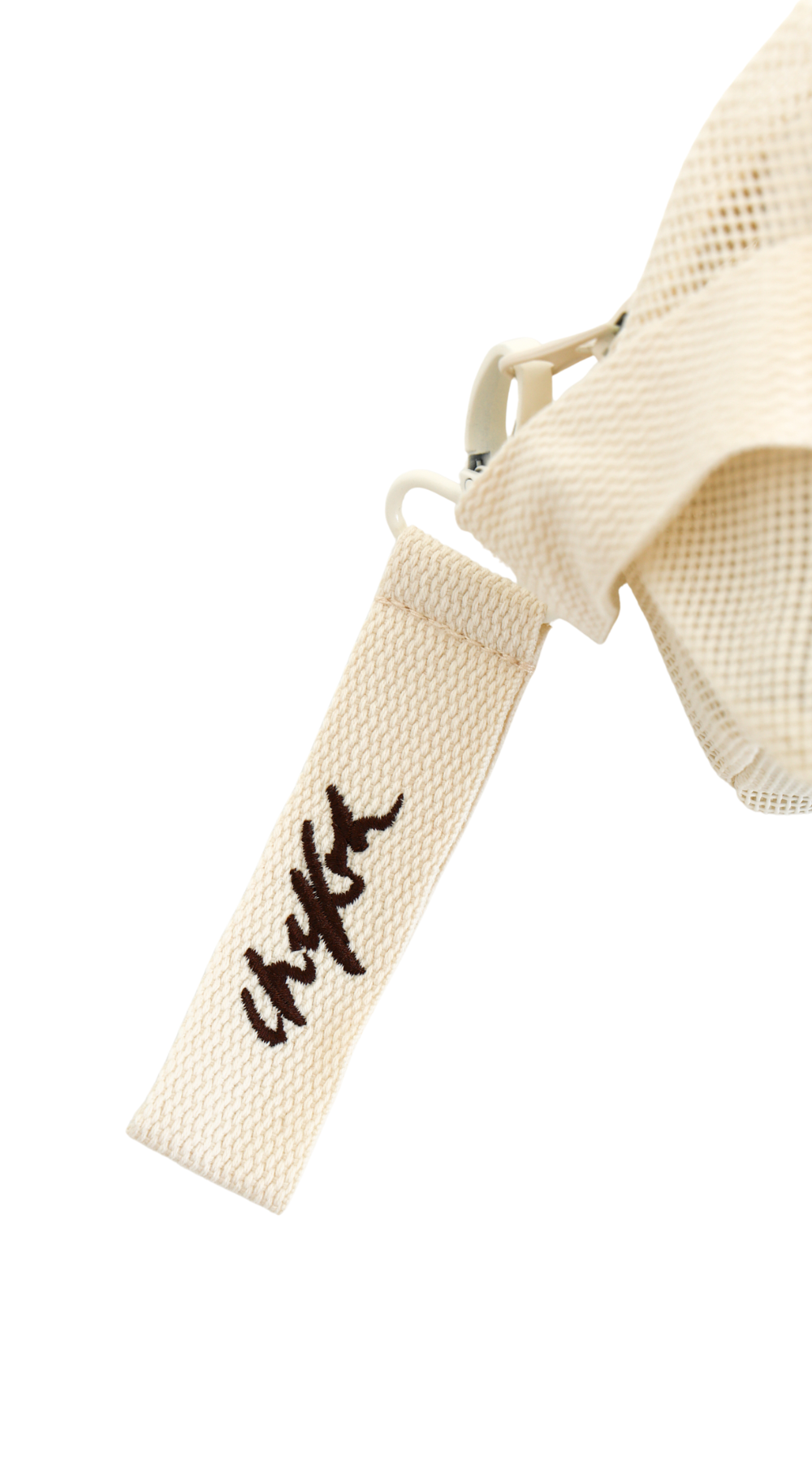 Close up of detachable embroidered Chekoh logo key ring - comes attached to the Clip Storage Bag.