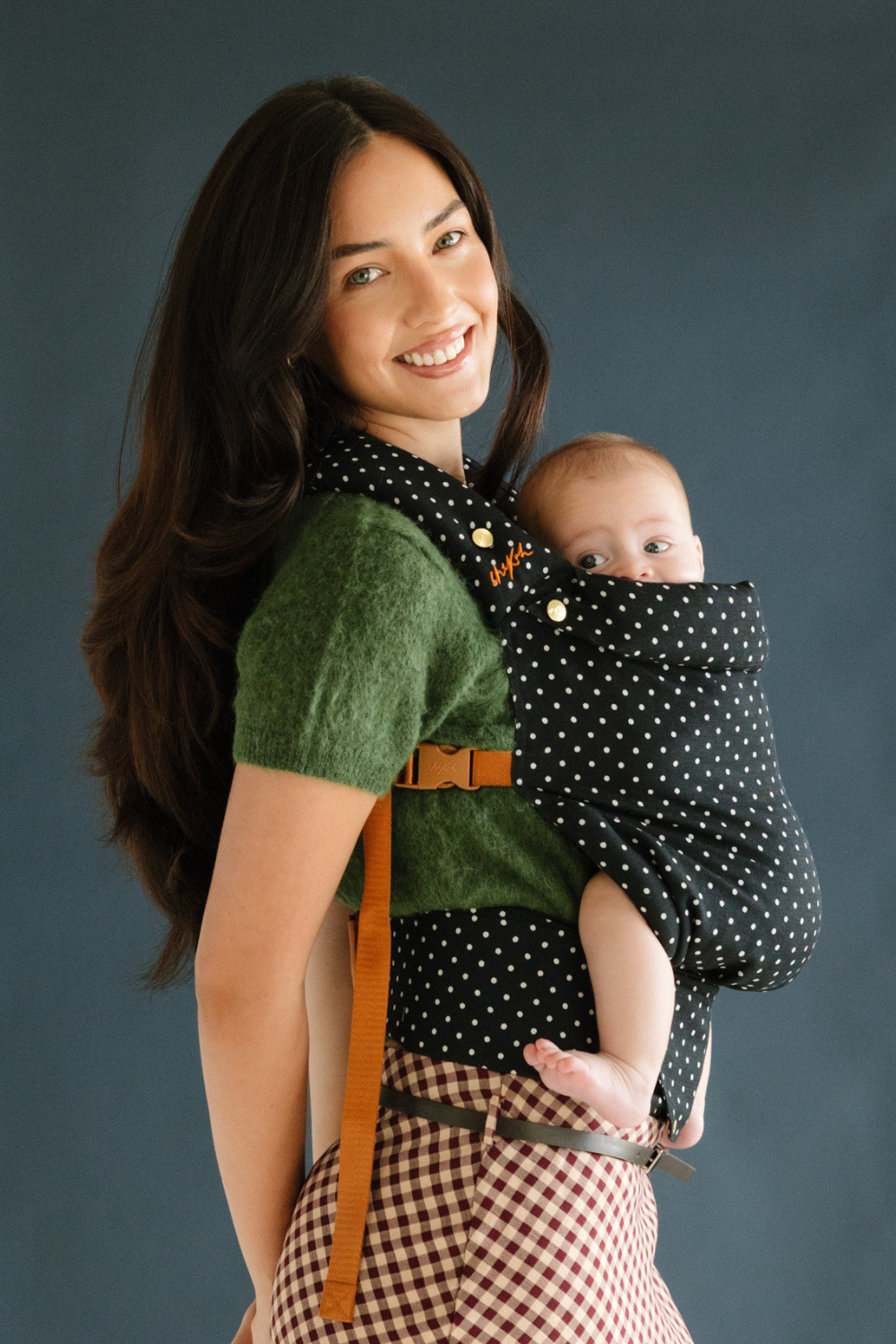 Mother smiles while baby wearing in the Chekoh Baby Polka Dot Clip Carrier, baby looks rested and content as well as close!