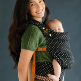 Mother smiles while baby wearing in the Chekoh Baby Polka Dot Clip Carrier, baby looks rested and content as well as close!