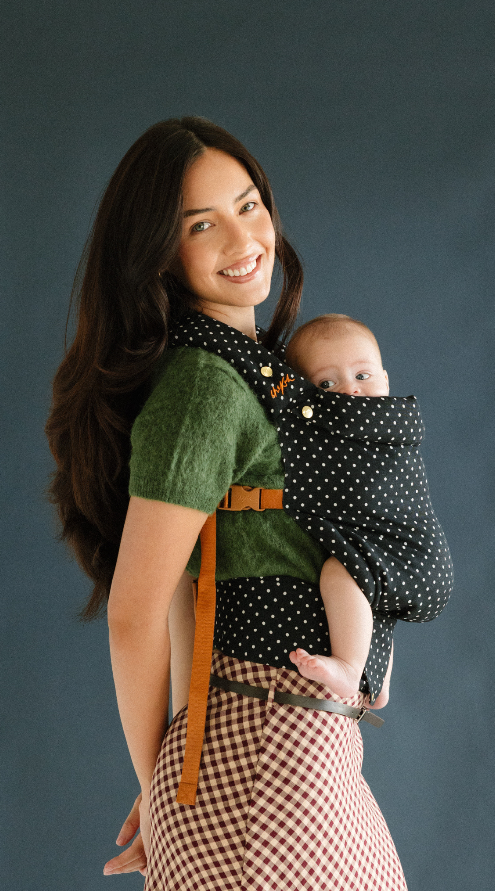 Mother smiles while baby wearing in the Chekoh Baby Polka Dot Clip Carrier, baby looks rested and content as well as close!