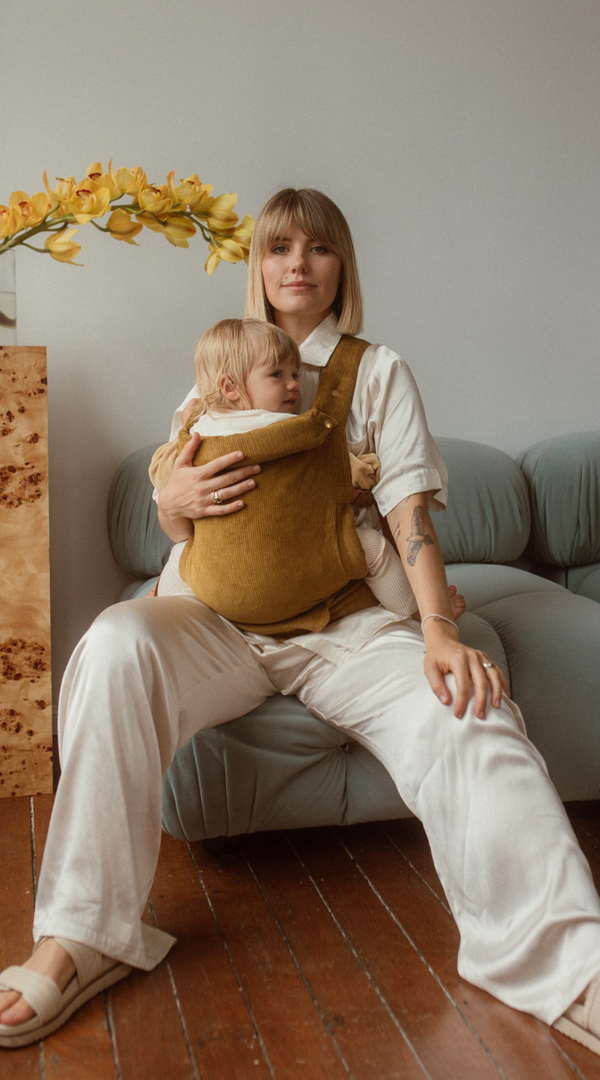 Shop the Ginger Cord Clip Carrier 2.0 for earthy golden mustard yellow green tones. Padded and size inclusive for a comfortable adjustable fit each and every time you babywear.