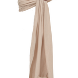 A sandy beige bamboo and linen Ring Sling Baby Carrier by Chekoh is on a white backdrop. 