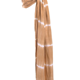 Cove Sling on a white backdrop. A caramel and white tie dye print Ring Sling Carrier by Chekoh baby.