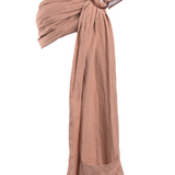 A Chekoh Terracotta Ring Sling Baby Carrier on a white backdrop. A neutral light terracotta tone. 