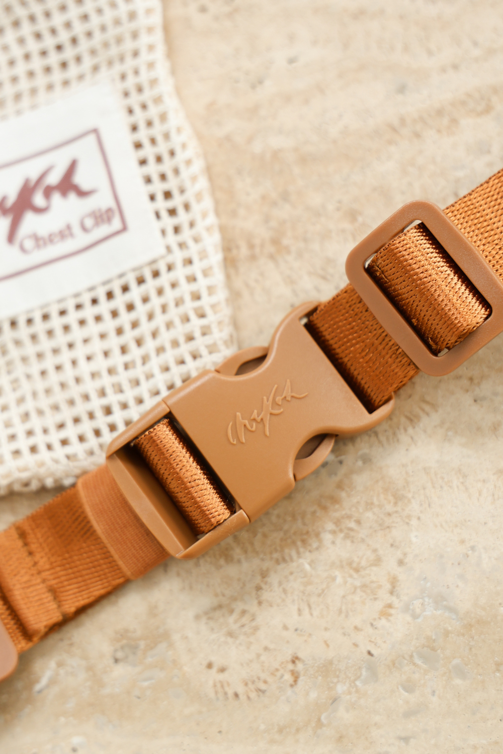 Close up of the Chekoh Chest Strap - including signature Chekoh golden brown strapping and buckle. Comes with a Cotton Mesh Storage Pouch.