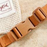 Close up of the Chekoh Chest Strap - including signature Chekoh golden brown strapping and buckle. Comes with a Cotton Mesh Storage Pouch.